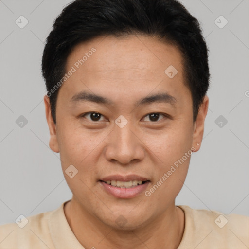 Joyful asian young-adult male with short  black hair and brown eyes