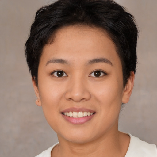 Joyful asian young-adult female with short  brown hair and brown eyes