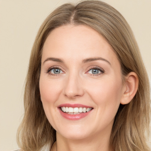 Joyful white young-adult female with medium  brown hair and green eyes