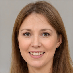 Joyful white adult female with long  brown hair and brown eyes