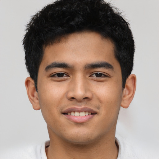 Joyful asian young-adult male with short  black hair and brown eyes