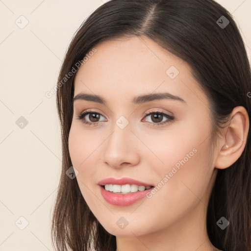 Joyful white young-adult female with long  brown hair and brown eyes