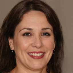 Joyful white adult female with medium  brown hair and brown eyes