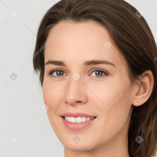 Joyful white young-adult female with long  brown hair and green eyes