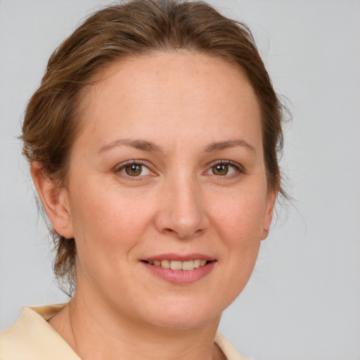 Joyful white young-adult female with medium  brown hair and brown eyes