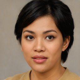 Joyful asian young-adult female with medium  brown hair and brown eyes