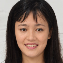 Joyful asian young-adult female with long  brown hair and brown eyes