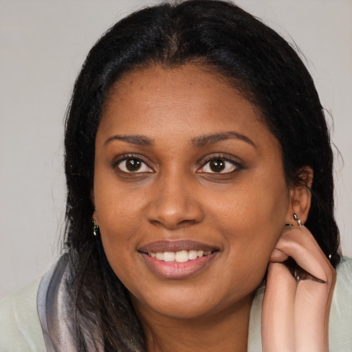 Joyful latino young-adult female with long  brown hair and brown eyes