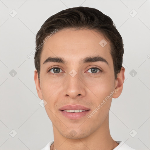 Joyful white young-adult male with short  brown hair and brown eyes