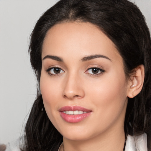 Joyful white young-adult female with long  black hair and brown eyes