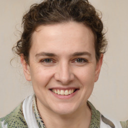 Joyful white young-adult female with medium  brown hair and blue eyes