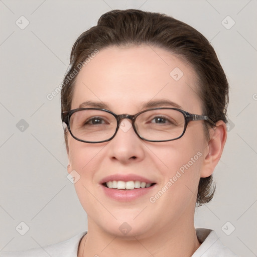 Joyful white young-adult female with short  brown hair and grey eyes