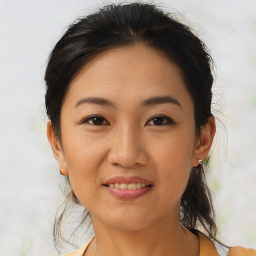 Joyful asian young-adult female with medium  brown hair and brown eyes