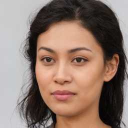 Joyful asian young-adult female with long  brown hair and brown eyes