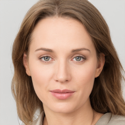 Joyful white young-adult female with long  brown hair and grey eyes