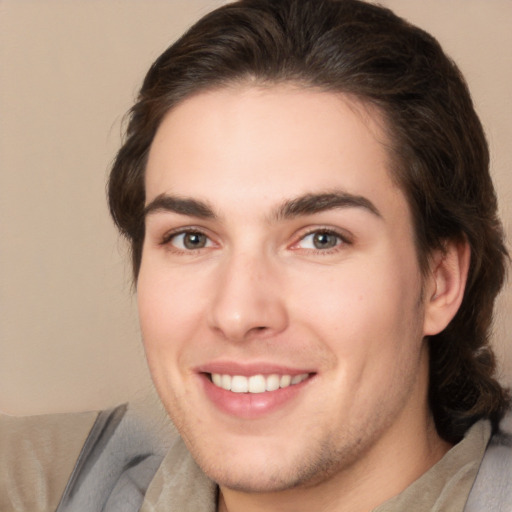 Joyful white young-adult male with medium  brown hair and brown eyes