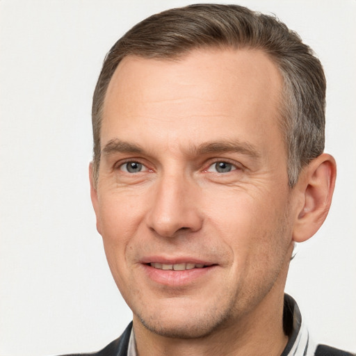 Joyful white adult male with short  brown hair and brown eyes