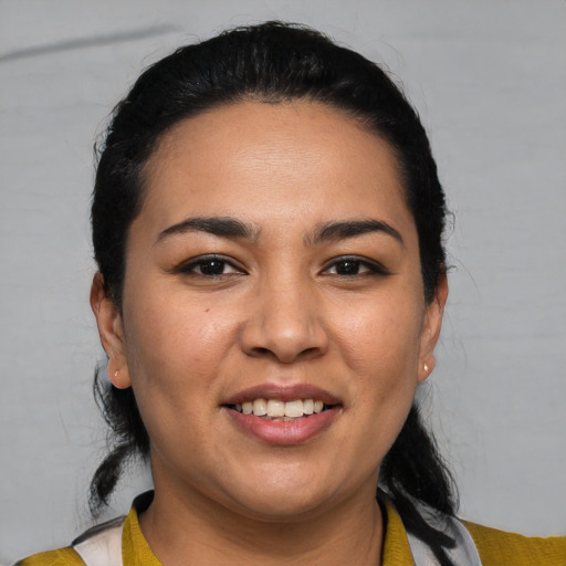 Joyful latino young-adult female with medium  black hair and brown eyes
