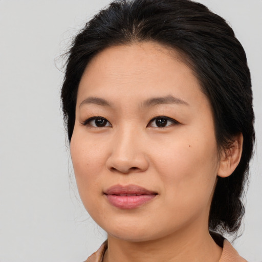 Joyful asian young-adult female with medium  brown hair and brown eyes