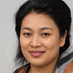 Joyful asian young-adult female with medium  black hair and brown eyes