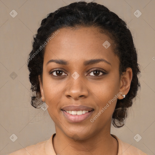 Joyful black young-adult female with long  black hair and brown eyes