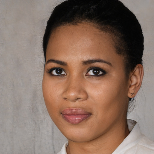 Joyful black young-adult female with short  black hair and brown eyes