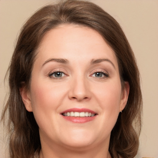 Joyful white young-adult female with medium  brown hair and green eyes