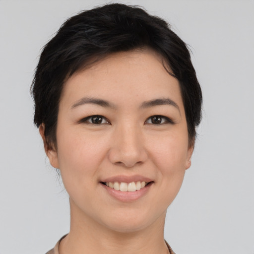 Joyful white young-adult female with short  black hair and brown eyes