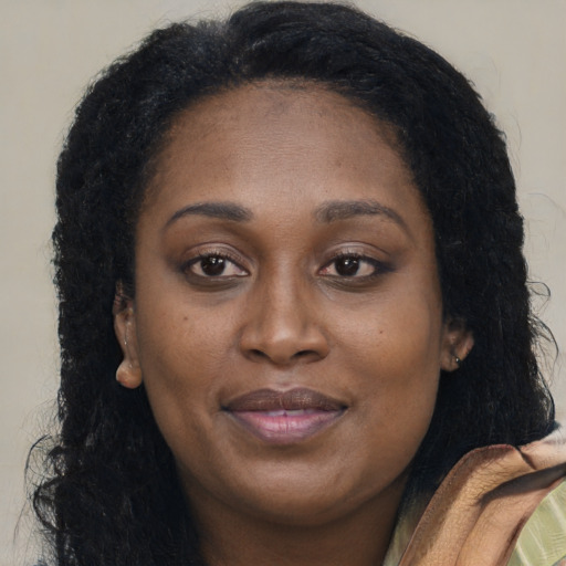 Joyful latino adult female with long  brown hair and brown eyes