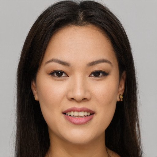 Joyful asian young-adult female with long  brown hair and brown eyes