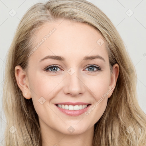 Joyful white young-adult female with long  brown hair and blue eyes