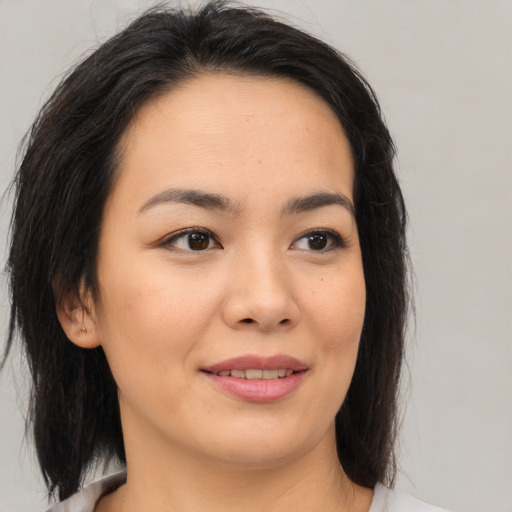 Joyful asian young-adult female with medium  brown hair and brown eyes