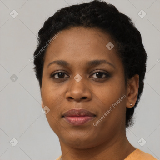 Joyful black young-adult female with short  black hair and brown eyes