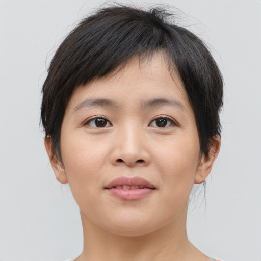 Joyful asian young-adult female with short  brown hair and brown eyes