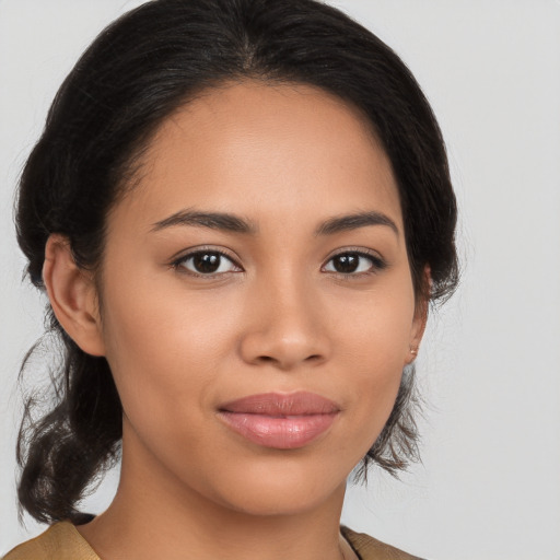 Joyful latino young-adult female with medium  brown hair and brown eyes