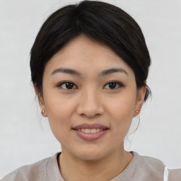 Joyful asian young-adult female with medium  black hair and brown eyes