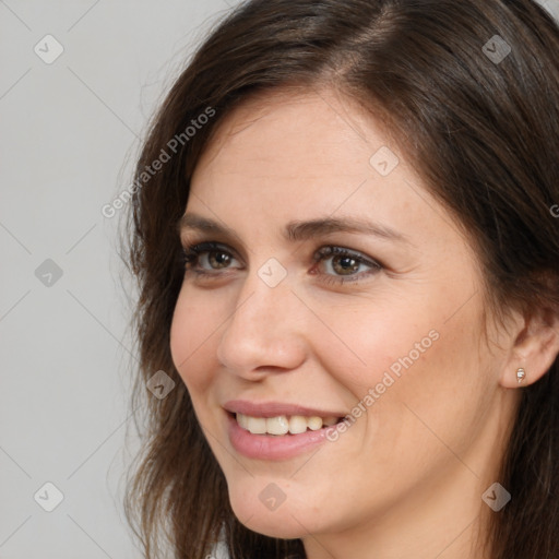 Joyful white young-adult female with long  brown hair and brown eyes