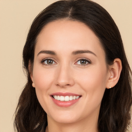 Joyful white young-adult female with long  brown hair and brown eyes