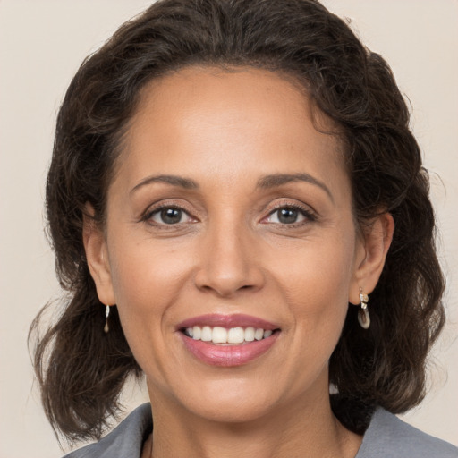 Joyful white adult female with medium  brown hair and brown eyes