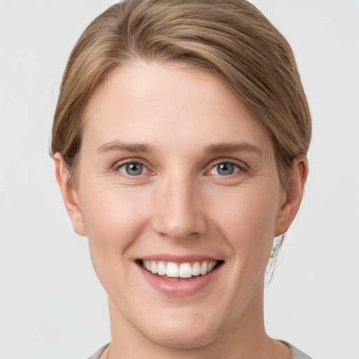 Joyful white young-adult female with short  brown hair and grey eyes