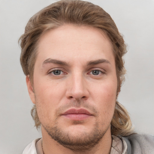 Joyful white adult male with short  brown hair and grey eyes