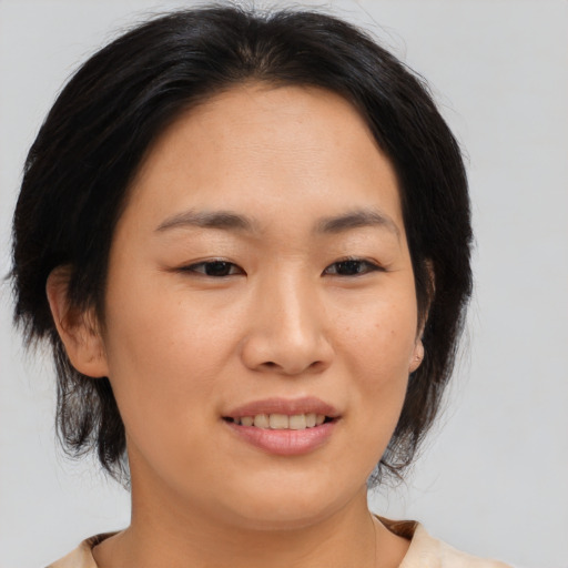 Joyful asian young-adult female with medium  brown hair and brown eyes