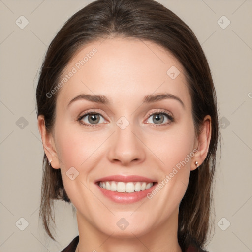 Joyful white young-adult female with medium  brown hair and grey eyes