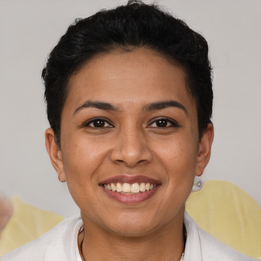 Joyful latino young-adult female with short  brown hair and brown eyes