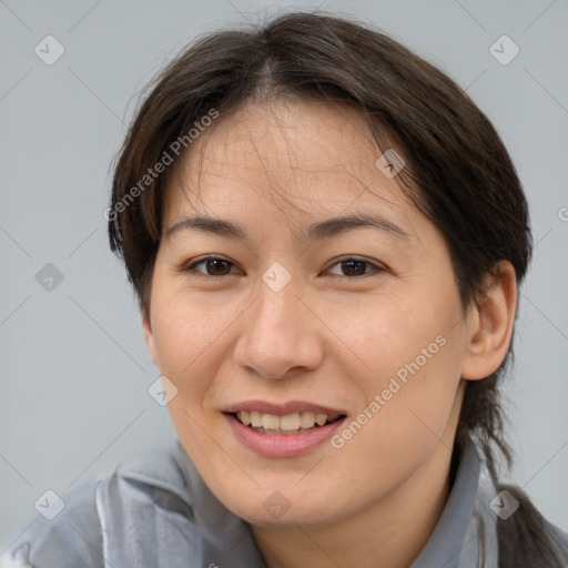 Joyful white adult female with medium  brown hair and brown eyes