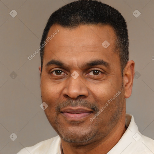 Joyful latino adult male with short  black hair and brown eyes