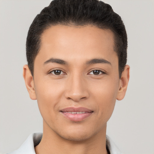 Joyful latino young-adult male with short  brown hair and brown eyes