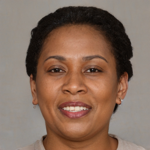 Joyful latino adult female with short  brown hair and brown eyes