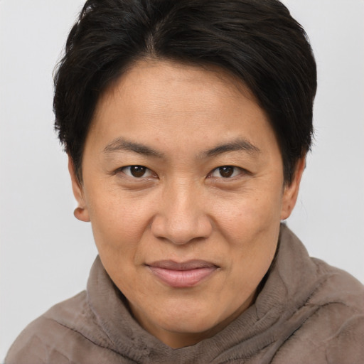 Joyful asian adult female with short  brown hair and brown eyes