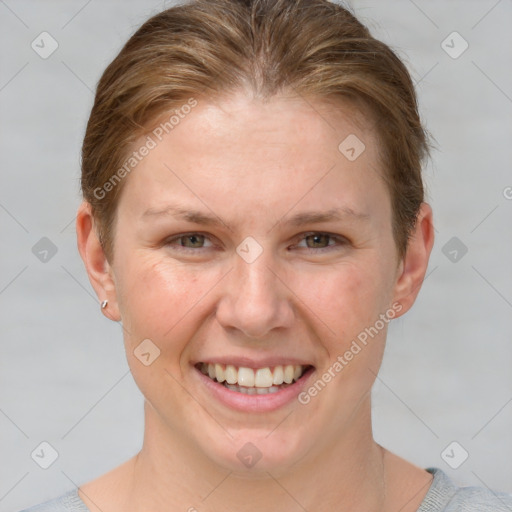 Joyful white young-adult female with short  brown hair and grey eyes